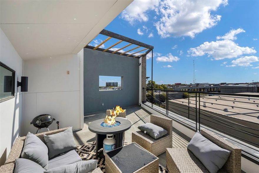 Unique opportunity for luxury urban living in sought after location... just around the corner from Deep Ellum, the Dallas Farmers Market, Fair Park, and more! This modern four story townhome features high end finishes throughout! Upon entering through the private 2 car garage, you will be greeted by stained concrete floors, a spacious guest suite with a full bath, and access to the enclosed outdoor patio! Ascend to the second floor, which offers gorgeous hardwood flooring and an open concept floorplan perfect for entertaining! The gourmet chef's kitchen is complete with stainless steel appliances, dual islands, quartz countertops, and a wine fridge! The expansive living room is complemented by floor to ceiling windows, allowing for plenty of natural light! Retreat to the oversized primary suite on the third floor where you can enjoy more views of the city! The luxurious spa-like bath is complete with vaulted ceilings, slate floors, a jetted tub, walk-in shower and a large walk-in custom closet! The versatile third bedroom and laundry room with a stunning industrial style slider door can also be found on the third floor! Enjoy breathtaking panoramic views of the Dallas skyline on the massive fourth floor rooftop patio! This outdoor space allows for plenty of space to entertain, highlighted with modern outdoor lighting, recently refinished decking, and a gas line for grilling! This one-of-a-kind property has had endless recent updates including a new roof in 2025, repainted throughout, refinished hardwood flooring, and more! No HOA!! Additional parking can be found in the gravel area behind property, which is owned by this unit!