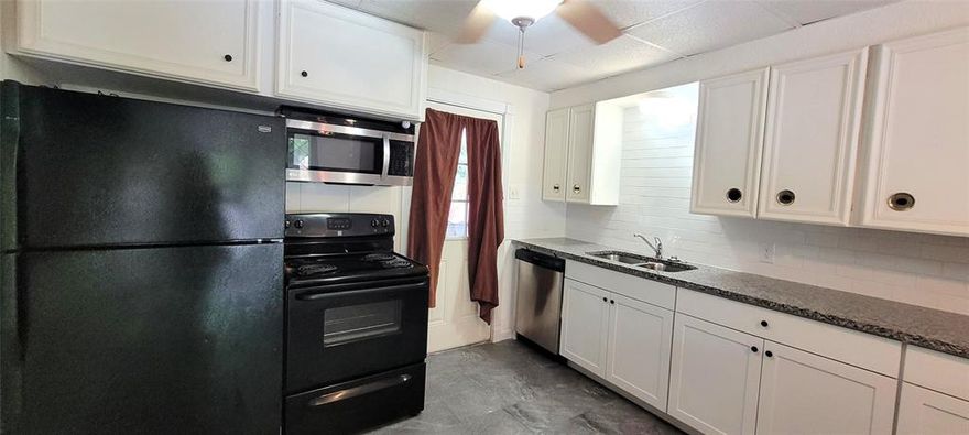 Cute 2 bedroom 2 bath home with big fenced backyard. Updated kitchen with black refrigerator and electric stove, stainless steel and black microwave and stainless steel dishwasher. All new counter tops with breakfast bar between the kitchen and living area. New wood looking flooring in kitchen, living and bedroom. Updated full bath with walk in tiled shower, tile flooring, and vanity. Double closets in one bedroom. Larger bedroom has an ensuite bath and a private office space. Bonus room could be a great space for your crafts or hobbies. Separate laundry room with storage closet, shelves, and pantry. Big privacy fenced backyard with multiple storage spaces. Two metal storage buildings. Workshop with workbench and shelves. Tool shed. Covered area for your riding lawn mower or motorcycle. Additional double door storage in back too. Basketball court, garden area, and concrete patio. Mature shade trees too. Easy access to Loop 820 and downtown Fort Worth.