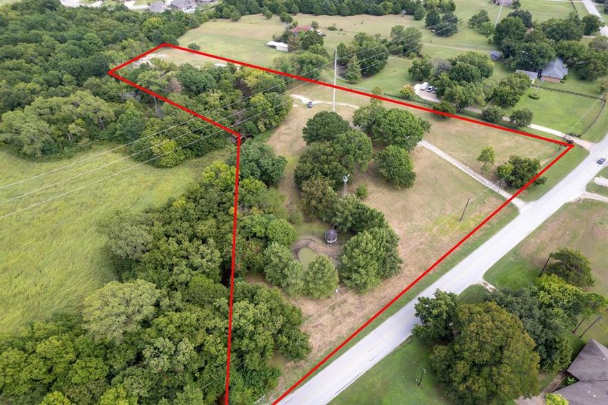 Rare opportunity to purchase nearly 5 acres of beautiful, secluded land right off of I-20! Best of both worlds being within city limits, but tucked away enough to have all the privacy you want with mature trees around. Cleared off and ready to build on, this property has multiple pad sites that could work depending on your vision! Includes a pond on property, along with a 30x40 metal shop for plenty of extra storage or hobbies. Electric has already been ran to the shop. Minutes away from Dallas, and right off the highway, it does not get more convenient than this!