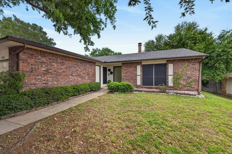 Step into this gorgeous home featuring an inviting front porch, spacious living room with soaring ceilings, rich luxury vinyl plank floor, abundant natural light, and a stunning brick fireplace that creates the perfect focal point. The bright and functional kitchen offers granite countertops, stainless steel appliances, ample cabinetry, and a convenient breakfast bar that opens seamlessly to the breakfast nook and second living room. Neutral tones and thoughtful updates throughout provide a clean, move-in ready feel with plenty of opportunity to make it your own. The expansive primary suite features a large window overlooking the private backyard, an en suite updated bathroom with shower only, and a neutral color palette that creates a bright and airy atmosphere.The updated secondary bathroom continues the clean aesthetic with white shaker-style vanity, brushed nickel fixtures, and classic subway tiling in the shower-tub combo.  Large sliding glass doors bring the outdoors in and lead to a covered patio and private backyard, ideal for morning coffee, weekend gatherings, or peaceful evenings at home. With move-in-ready finishes and a functional layout, this home provides a sophisticated and versatile canvas for its next owner. Home feeds into highly acclaimed Martin HS and is conveniently located near Lake Arlington, multiple parks, shopping, dining, and offers great access to highways.