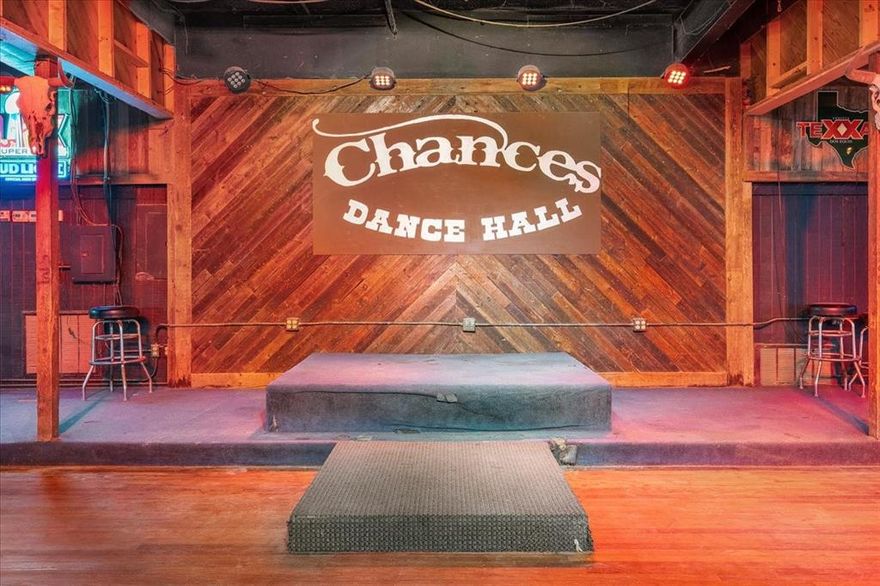 Own a legendary Texas dance hall—still available for lease too! Step into a rare opportunity to purchase a true Cleburne landmark. Chances Dance Hall, a beloved nightlife and entertainment venue since 1983, is now offered for sale and actively for lease. Located at 3121 N Main Street, this iconic 5,600+ SF freestanding building sits on just over one acre with bold street frontage and signage.

The space is fully outfitted and ready to bring your bar, restaurant, nightclub, or live event concept to life. Inside, you’ll find a large elevated stage with lighting, a full wraparound bar with seating, a wood dance floor, concrete floors, spacious restrooms, and a rustic Western aesthetic with neon signage and wood-paneled walls. A dedicated food service window and back kitchen prep area offer built-in potential for food service or vendor partnerships. The open layout supports both large public events and private parties with ease. Ample on-site parking and strong visibility from N Main make this property ideal for an owner-user or investor.

Even better—over 300 new homes and a brand-new apartment complex have just gone in across the street, boosting future traffic and upside potential. An Amazon distribution center is also being built less than 5 miles away, expected to employ over 1,000 workers—bringing even more economic growth and visibility to the area. Chances Dance Hall has hosted decades of memories and loyal crowds—now it’s ready for its next chapter. Own it, lease it, or bring your buyer-tenant. Contact agent for full terms.
