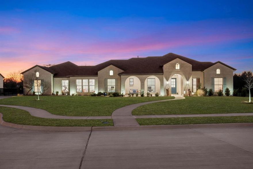 One-of-a-kind custom-built residence nestled on nearly an acre by Lake Ray Hubbard. Thoughtfully designed and beautifully crafted, this home showcases distinctive architectural details — exposed wood beams in the living area, a striking coffered ceiling in the primary suite, custom cabinetry and concrete flooring. With the custom closet and an oversized spa-like shower in the main suite, you will find it to be a true retreat.
A wall of windows frames the expansive backyard, filling the home with natural light and creating a seamless connection to the outdoors. Step outside to enjoy a built-in outdoor kitchen, a firepit, and a generous yard backing to peaceful greenbelt views — creating the perfect setting for entertaining, family gatherings, or quiet evenings under the Texas sky.
Located near within the walking distance to the lake, the setting only gets better: 2 tennis clubs, 10 golf courses, Heath Yacht club and Chandlers landing - all within a 10 min distance. Zoned for the highly acclaimed Rockwall ISD, this home is a gem of true luxurious living.