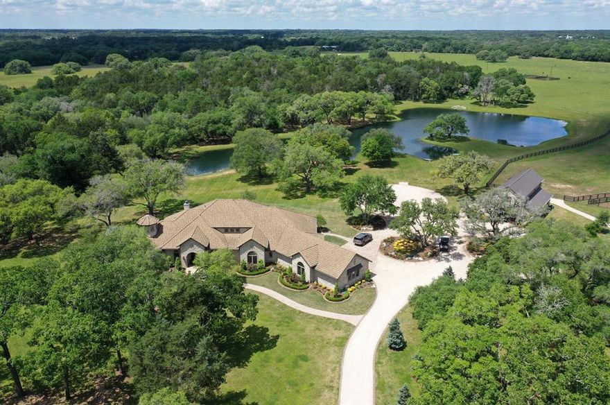 This beautiful 70 plus or minus acres ranch, known as the Hamptons for Houston Ranch Buyers, is located just an hour away from downtown Houston and 90 minutes from Austin. It features a custom-built single-story home with 3 bedrooms, 2.5 bathrooms, and luxurious amenities like a game room, media room, and a gun room. The ranch is surrounded by stunning live oaks and a 3-acre lake, providing a peaceful oasis. Additionally, there is a well-designed horse barn with a 1-bedroom apartment above, a riding arena, and horse paddocks. The property has road frontage with split rail fencing and multiple custom driveway gates. With its prime location, beautiful landscape, and ample amenities, this ranch offers a perfect retreat from city life. *Additional Acreage Options Available* (See Agent for details) *Estimated tax information is based off the current tax rate of 1.797319 and 1.704062 for the entire 215 acres. Tax information for smaller acreage option TBD, Buyer and Buyer's Agent to verify.