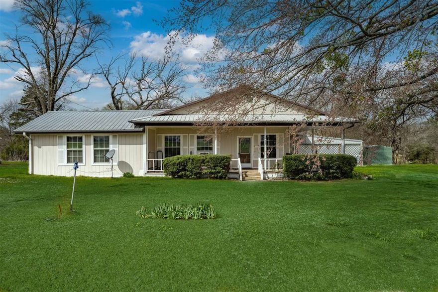 Charming country home located on a quiet rural road with convenient access to the Clarksville Country Club and North Lake. This inviting property offers the peaceful feel of country living while still being just minutes from local amenities.



The home welcomes you with a spacious wraparound front porch extending along two sides of the house—perfect for enjoying slow mornings with coffee or relaxing evenings while taking in the surrounding countryside.



Inside, the open floor plan creates a comfortable and functional living space. The kitchen features beautiful oak cabinetry, generous workspace, and flows easily into the main living area. Recent flooring and fresh interior paint give the home a clean, updated feel throughout. Bathrooms have been tastefully updated, adding both style and convenience.



Additional features include a durable metal roof, attached carport for covered parking, a shop building, and an extra storage building—providing excellent space for hobbies, equipment, or additional storage.



Whether you’re looking for a starter home, a peaceful place to downsize, or a quiet country retreat, this property offers comfort, charm, and practical amenities in a desirable location.



Come experience the charm and possibilities this home has to offer.