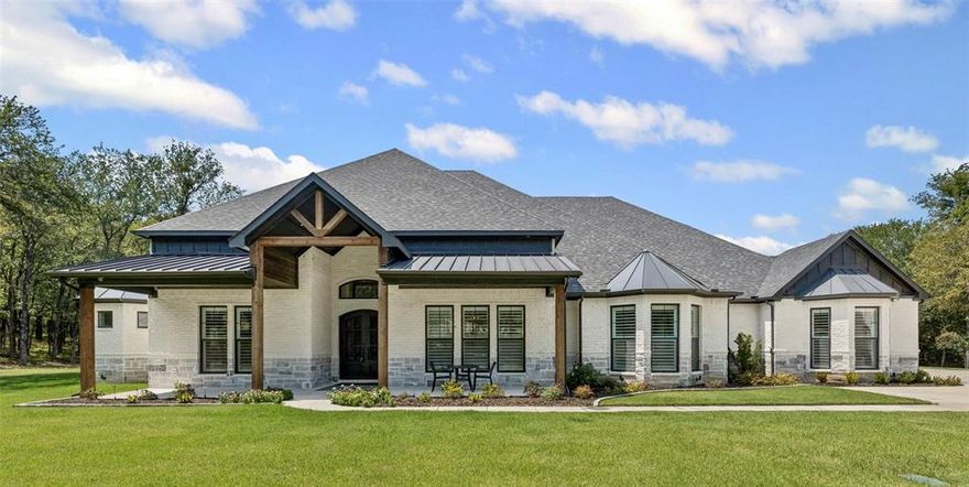 Experience modern luxury in this stunning single-story home with detached carriage house, set in a serene gated community between Granbury & Fort Worth. Enjoy private lake access, abundant wildlife & a close-knit atmosphere.
The main home features soaring ceilings, 8-ft solid doors & an open layout. The chef’s kitchen boasts a 48” Wolf gas range, Sub-Zero built-in fridge, Monogram Café dishwasher, microwave & double wall ovens. Wine lovers will enjoy the climate-controlled, LED-lit glass wine cellar holding 276 bottles.
Luxury touches include plantation shutters, Sonos indoor, outdoor audio, AV closet, and dual gas, wood fireplaces. The oversized 4-car garage offers an underground storm cellar.
Outdoors, entertain in a resort-style heated pool & spa with swim-up bar, in-pool stools, gas-plumbed patio, and Mistaway mosquito system.
The carriage house includes a full kitchen, bath, open living, and a 14-ft oversized 2-car garage with custom cedar doors and an 8'x8' gun-storm shelter.
Safety & comfort are ensured with 2 storm cellars, a 38KW Generac generator for the full home & 1,000-gal owned propane tank.
A rare blend of modern elegance, privacy & top-tier amenities.