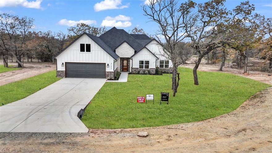 Builder offering interest rates as low as 5.125%—an incredible chance to lock in country luxury at a lower rate! Welcome to Garner Ranch in Brock ISD — where modern design meets country serenity. Set on a beautifully treed 1-acre lot, this brand-new 2,100 sq ft home offers the perfect blend of open-concept living and refined craftsmanship. Inside, soaring vaulted ceilings with striking box beams draw your eye upward, while the seamless flow between the living, dining, and kitchen spaces makes entertaining effortless. Enjoy Luxury Vinyl Plank floors throughout whole home with beautiful tile in bathrooms. The kitchen is a true showpiece, featuring a large island with quartz countertops, stainless steel appliances, and custom shaker-style cabinetry — with a rich stained knotty alder island and lowers complemented by beautifully painted uppers for contrast and warmth. A walk-in pantry and abundant storage complete the space. The spacious dining area overlooks the private backyard, where a covered patio provides the ideal spot for morning coffee or evening gatherings beneath the trees. The split-bedroom layout includes four large bedrooms, including a stunning primary suite with a tray ceiling accented by horizontal box beams and peaceful backyard views. The spa-inspired ensuite offers a soaking tub, dual sinks with quartz counters, elegant tilework, and a massive walk-in closet. Landscaping will include a full sprinkler system, lush sod, and thoughtfully selected plants to enhance the home’s welcoming curb appeal. Additional highlights include a large mudroom, full laundry room, powder bath, and a 2-car garage. Estimated completion: December 2025 — ready for its first proud owner to make it home. Crafted with care and character, this Garner Ranch gem captures the essence of upscale rural living—set on a stunning, tree-filled one-acre lot where quality construction meets everyday comfort.