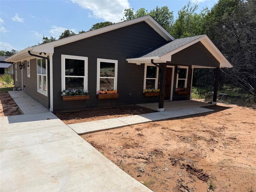 Patriot Homes is happy to present this 3 bedroom, 2 bathroom 2024 craftsmen-style home. This home is nestled in a peaceful countryside setting with mature trees in a wildlife environment. It's located in Comanche Harbor giving all owners access to a boat ramp on Lake Granbury! The trendy kitchen has beautiful granite countertops, stainless steel appliances, and cabinetry for storage. The master bedroom has a spacious walk in closet while the primary bathroom has granite countertops and storage space. With its unique blend of rustic charm and a modern look, this home is the perfect retreat for those seeking a peaceful escape from the city life. It's conveniently located with a short drive to Granbury's charming downtown shops, restaurants, the lake, and more! Sod will be placed before closing. 
Public Driving Directions: GPS friendly