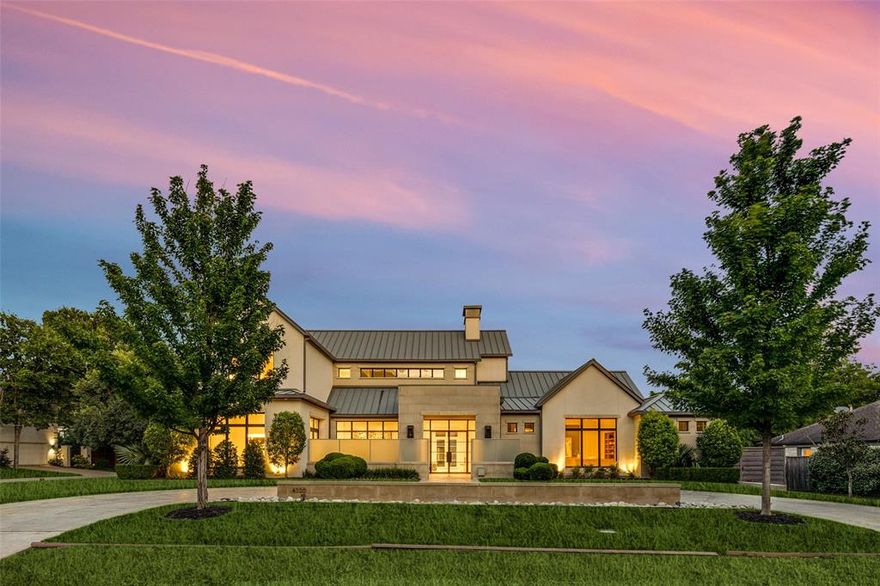 Nestled on a prime corner lot in the heart of prestigious Bluffview, this exceptional estate spans nearly half an acre and defines timeless sophistication, privacy, and architectural excellence. Offered for the first time, this 2016 custom-built by Phillip Jennings Custom Homes residence has been meticulously designed with an uncompromising eye for detail—where modern refinement meets elevated everyday living.
Crafted for both grand-scale entertaining and intimate comfort, the home features 6 bedrooms, 7.3 bathrooms, a formal office suite, gym, and expansive indoor-outdoor living areas. A dramatic living room with soaring ceilings and a statement fireplace anchors the open-concept design, flowing seamlessly into the chef’s kitchen—equipped with professional-grade appliances, a full-service bar, and a generous butler’s pantry. The private primary suite on the main level serves as a tranquil retreat, complete with spa-inspired amenities. Upstairs, secondary bedrooms offer en-suite privacy and are joined by a versatile game room and fitness space.
Surrounded by lush, manicured grounds, the outdoor living experience includes multiple gathering spaces, ideal for both entertaining and quiet relaxation. Located just minutes from Dallas' most renowned private schools, elite dining, luxury shopping, and premier FBOs at Love Field and Addison Airport, this residence combines location, design, and lifestyle at the highest level. This home is enhanced by too many features to list starting with automatic shades, steal reinforced tornado-safe room, full home Generac generator, oversized four car garage, multiple outdoor kitchen areas, Wi-Fi lighting, steam shower and more. This is a rare opportunity to own one of Bluffview’s finest homes—crafted with intention, and ready to inspire.