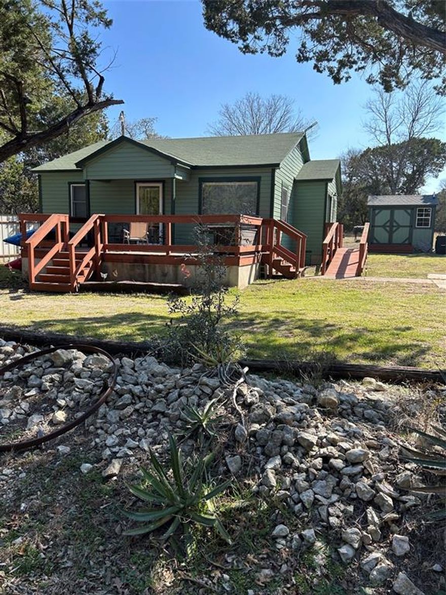 Precious Lakehouse!  This darling 2-1.5 has been remodeled, original hardwood floors, great kitchen with lots of cabinets. bath with large shower.  Storage building has full size washer & dryer & half bath. Over a third of an acre.  Great neighborhood!  Will sell furnished.  Seller is a Texas Licensed Realtor