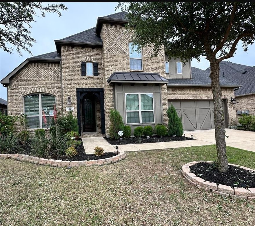 Experience elevated living in this stunning two-story residence nestled in the highly desirable Vineyards community. Boasting 5 bedrooms and 4 full baths, this home blends sophistication with functionality. The main-level primary suite offers a private retreat with a walk-in closet connected to an oversized utility room, while a secondary bedroom and full bath downstairs provide comfort for guests.
Step inside to soaring ceilings and a grand living space highlighted by an 18-foot ceiling and elegant fireplace. Rich hardwood flooring flows throughout the first level, enhancing the open-concept design ideal for both intimate living and upscale entertaining.

Upstairs, enjoy a spacious game room and a dedicated media room designed for relaxation and gatherings. A 3-car tandem garage completes the home’s impressive features.

Perfectly positioned near Lake Ray Hubbard, Lakeside Park, and Paddle Point Park, residents enjoy scenic trails, water activities, and breathtaking sunsets. With convenient access to I-30, President George Bush Turnpike, and Highway 66, plus close proximity to premier shopping and dining, this home offers both luxury and lifestyle.
