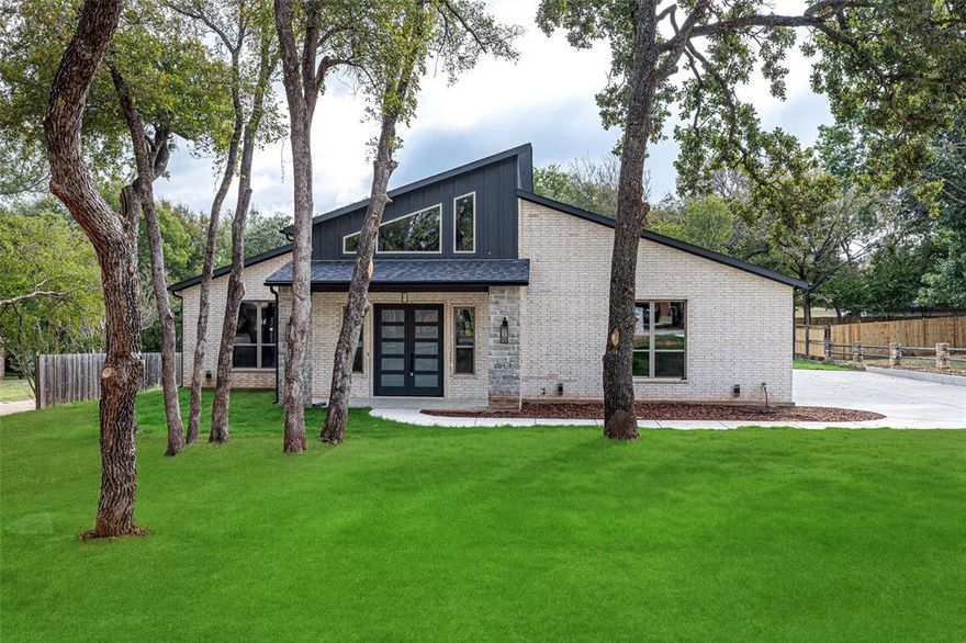 Modern design and timeless craftsmanship combine in this 2,344 sqft home situated on a .354-acre lot in the highly sought-after gated community of Pecan Plantation. The open-concept floor plan features soaring ceilings, quartz counters, luxury vinyl plank flooring, and a stunning electric fireplace framed by stone and wood accents. The kitchen showcases custom cabinetry with a rich green finish, quartz countertops, designer lighting, and a large island perfect for entertaining. A walk-in pantry and adjacent utility room with built-ins provide abundant storage and functionality, while the large laundry room offers a convenient folding table and plenty of natural light. The spacious primary suite offers a spa-like bath with dual vanities, elegant gold fixtures, and a walk-in shower. Secondary bedrooms feature generous closets and modern finishes throughout. Additional highlights include energy-efficient windows, a covered entry, and contemporary lighting inside and out. Enjoy all that Pecan Plantation has to offer—golf, equestrian facilities, tennis, parks, and convenient access to the clubhouse, marina, and more—all within a short drive to Lake Granbury and shopping on the Square. Plat available, buyer to purchase survey if needed, Pecan Plantation has a $5500 Membership & Transfer Fee that the buyers will be required to pay. Sod hasn't taken root in the yard yet - Photos of the exterior lawn have been digitally enhanced