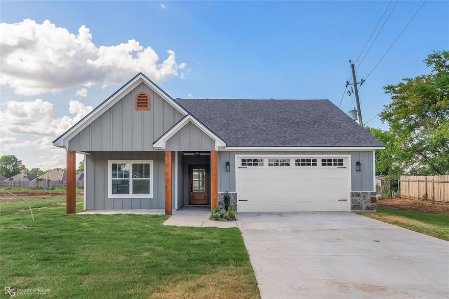 BRAND NEW CONSTRUCTION IN SOUTH BOSSIER, SITUATED IN THE RECENTLY DEVELOPED PARKWAY PLACE! The Hemsworth features a practical and open-concept design with three bedrooms and two bathrooms. The exterior is adorned with stunning stone accents and solid cedar beams. Inside, you'll find a neutral color palette, a stone fireplace with gas logs, an eat-in kitchen, a pantry, and a secluded master suite!
Upgrades for this home include luxury wood-look ceramic tile flooring, custom REALWOOD locally built cabinets and quartz countertops throughout, a gas appliance package (range, hot water heater, & furnace), and more! Notable features include:  a double vanity, garden tub, separate shower, and a walk-in closet in the primary suite, covered rear porch, recessed can lighting, undermount sinks, black cabinet hardware, smoke and carbon monoxide detectors, automatic garage door with 2 remotes, landscaping, architectural 30-year shingles, flood lights, and more! Located just minutes from BAFB, local shopping and dining, for easy access to all areas of town. Call now to schedule an appointment to see this property!