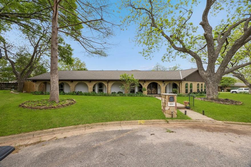Seller is offering up to $6,000 in concessions to buyer closing costs. Discover timeless appeal and versatile living at 3211 Glasgow Terrace, a distinctive 4-bedroom, 3.5-bath home offering 3,485 square feet on an oversized corner lot in a quiet cul-de-sac framed by mature pecan trees. Built in 1972 and thoughtfully updated, this home blends classic character with meaningful modern improvements, creating a comfortable and flexible space for today’s lifestyle.

Inside, soaring ceilings and abundant natural light set a welcoming tone—enhanced by 32 custom double-pane windows installed in 2022. The home also received new insulation in 2022, boosting efficiency and year-round comfort. Open-concept living areas make everyday living and entertaining effortless, while the kitchen offers extensive cabinetry, generous counter space, and updated hardware and hinges for a fresh, modern feel. Throughout the home, new fixtures and switches add cohesive style and function.

A unique three-way split bedroom layout offers exceptional privacy, perfect for guests, multi-generational living, work-from-home needs, or dedicated hobby spaces. Major system upgrades include a water heater replacement in 2020 and an extensive French drain system installed in 2024. The oversized garage provides extra storage, workspace, and an EV charger, adding convenience for modern living.

The backyard is both peaceful and low-maintenance, featuring established fruiting plants—blueberries, raspberries, blackberries, and plums—and artificial turf for year-round greenery. Covered porches extend your living space outdoors, offering inviting spots to relax or entertain. The large lot also provides room to expand or customize.

Additional highlights include a durable 40-year roof installed in 2019 and abundant storage throughout, with at least two closets in every bedroom. Set in a mature, convenient neighborhood, this home offers character, space, and lasting value—a rare find.