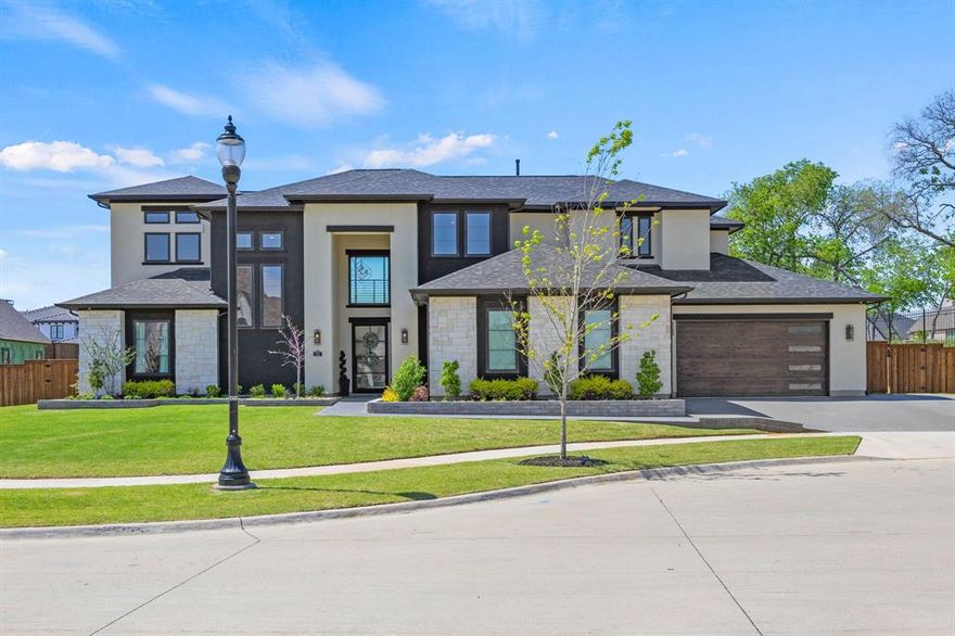 MODERN MASTERPIECE IN THE EXCLUSIVE PINNACLE AT WINDSONG RANCH-- Situated on one of just 40 half-acre estate lots in Prosper’s premier, award-winning master-planned community, 381 Spade Ranch is tucked away on a quiet cul-de-sac and sides to a serene greenbelt with mature trees—where whimsical fireflies glow on warm summer evenings, creating a truly magical setting. Step inside to a dramatic two-story foyer framed by walls of windows overlooking the resort-style backyard. The outdoor living space is exceptional, featuring a modern geometric pool with spillover spa, tanning ledge, and water feature wall with fire bowls. Multiple covered patios, an outdoor kitchen, and a firepit create the perfect setting for entertaining or relaxing while enjoying stunning Texas sunsets. The expansive yard offers ample space for a sport court or putting green! Inside, the home is thoughtfully designed for everyday living and entertaining. The chef’s kitchen is anchored by an oversized center island with two refrigerated drawers, double ovens, a 6-burner gas range with griddle and pot filler, and abundant custom cabinetry. Just off the dining area, a dedicated wine room with beverage fridge adds convenience and style. The downstairs entertainment room with pool bath is ideal for game days or movie nights and features 9-foot sliding doors that open to the covered patio, creating seamless indoor-outdoor living. The primary suite is a luxurious retreat with a fireplace, private patio access, and a spa like ensuite featuring two-story ceilings, a soaking tub, a walk-through shower with dual shower heads, and separate vanities. The first floor also includes a private office with built-in shelving and a guest suite with full bath. Upstairs, two additional bedrooms with ensuite baths are complemented by a spacious entertainment room with its own half bath.  Other highlights include a central vacuum system, two walk-in attic spaces, and an oversized three-car garage with room for a golf cart.