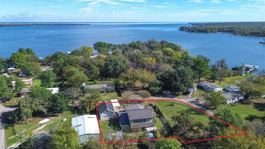 Discover this beautiful 5 bedroom, 4 bath 2 story home located at lake Tawakoni, offering approximately 2,500 sq ft of comfortable living space on an oversized lot. Designed for everyday living and entertaining, this updated home delivers generous indoor and outdoor gathering areas. The back porch is already piped for a future outdoor kitchen of your dreams, take in peaceful lake views from the upstairs balcony. A rare highlight is the second primary bedroom with a private ensuite offering excellent flexibility for multi-generational living or guests. Additional property features include a greenhouse, oversized 2 story detached garage and covered RV parking. With its lakeview setting, oversized lot and versatile layout, this property offers incredible potential as a full time residence, vacation home, or income producing investment.