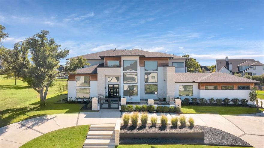 Welcome to an exquisite modern masterpiece that offers luxurious living at its finest. This home's character becomes truly evident in its open-concept design boasting impressive 23-foot ceilings and large windows that ensure an abundance of natural light. The gourmet kitchen, spacious dining area, and cozy living space are seamlessly interconnected. The kitchen is a chef's dream, featuring high-end appliances, and large island for both cooking and casual dining. Each of the 5 bedrooms boasts its own ensuite bathroom, ensuring privacy and comfort for family and guests. The backyard is a true oasis, featuring a magnificent pool-spa combination with tanning ledge. You'll also find a cabana and a full outdoor bathroom for added convenience. Entertaining is a breeze with covered patio, complete with a fireplace and fully equipped outdoor kitchen. Enjoy top-rated schools, parks, and nearby Lake Ray Hubbard for outdoor recreation.