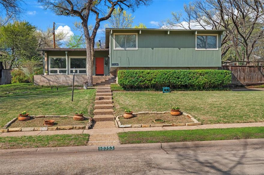 Architecturally significant Mid-Century Modern designed by the renowned Dallas team Ju-Nel and proudly listed on the Ju-Nel Register. Thoughtfully positioned atop a gently rolling hill, the home was designed to embrace its tranquil creek view and lush natural surroundings. Mature trees and a serene setting create a true sense of private retreat. 

Inside, authentic Mid-Century Modern character remains beautifully intact. Original wood and brick floors anchor the living spaces, while the striking original fireplace serves as a timeless focal point. Expansive windows flood the home with natural light and frame peaceful views of the surrounding landscape. 

The kitchen makes a bold design statement with its vibrant red sink and dramatic red accent lighting. This unforgettable space captures the playful spirit and distinctive style of the mid-century era while remaining fully functional for everyday living. 

Generously proportioned rooms provide comfortable spaces for both living and entertaining, complemented by abundant storage throughout. The home sits on 0.295 acres and is located just minutes from White Rock Lake, offering convenient access to one of Dallas’s most beloved destinations for walking, cycling, and enjoying nature. 

An oversized garage provides exceptional flexibility with ample room for a workshop, gym, hobby studio, or additional storage. A rare opportunity to own an authentic piece of Dallas architectural history, beautifully preserving the integrity and timeless design of a Ju-Nel Mid-Century Modern home.