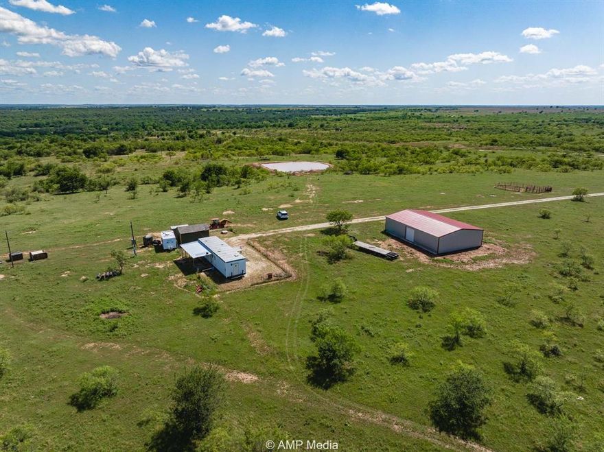 Located just outside the charming town of Nocona, this 80.3-acre property in Montague County offers a ready-to-go setup for ranching, recreation, or a peaceful country getaway. The property is fully fenced with high-quality 5-strand barbed wire and includes cross fencing and a cattle guard, providing easy access and secure boundaries for livestock or property management. Water Sources: Electric well with submersible pump approximately 15 GPM, Solar-powered well approximately 10–12 GPM. Improvements:60×40 metal barn built in 2023 with dual roll-up doors, concrete footings, and spray foam insulation – perfect for storing equipment, hay, or workshop conversion 48×12 skid-mounted man camp furnished, ideal for weekend stays. Wood-framed utility shed approximately 3 years old, with electrical service. Land Features: Rolling topography, mature hardwoods including oaks and a wild plum grove, two earthen stock tanks approximately 15 ft deep, and a great balance of cleared and native terrain. Wildlife & Habitat: Excellent habitat for white-tailed deer, turkey, dove, feral hogs, and other native wildlife. Ideal for hunting, nature enjoyment, or habitat conservation. This is a rare opportunity to own a well-maintained and highly functional property in a quiet, scenic area—ready for immediate use.