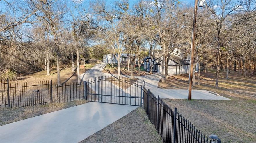 Welcome to your private Texas retreat on 6 quiet, fully fenced acres. Tucked behind an electric gate, this property offers room to breathe, play, and expand; whether you dream of building a second home, riding dirt bikes, or simply enjoying peaceful country living. The main home features 3 bedrooms + a bonus room that works perfectly as an office or additional bedroom, along with 2 full bathrooms and cozy living room for family time. Just steps away, the shop includes a full guest suite complete with a bedroom, full bathroom, kitchen, private living space, and even additional laundry hookups; an ideal setup for guests, a man cave, multigenerational living, or rental potential. Outside, you’ll love the circle drive, the open land ready for animals or adventures, and the quiet, tucked-away feel while still being close to town conveniences. A rare blend of privacy, versatility, and acreage; this property is ready to become whatever you imagine next.