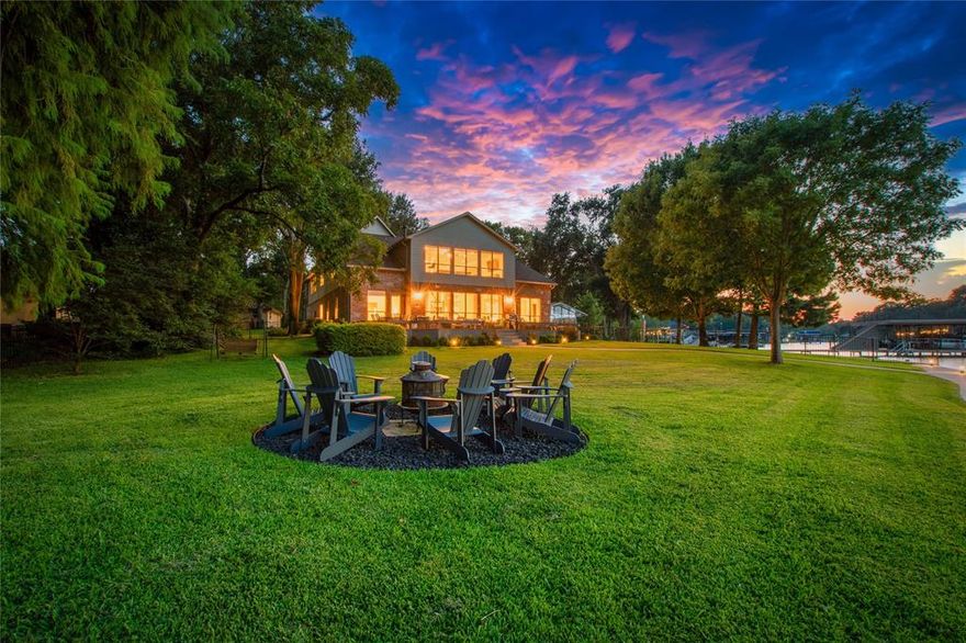 Situated on a stunning half-acre waterfront lot with an impressive 198 feet of shoreline, this expansive 5-bedroom, 3.5-bath home offers breathtaking open water views and deep water access in one of Cedar Creek Lake’s most desirable subdivisions. Perfect as a full-time residence, vacation retreat, or short-term rental, this home is designed for hosting and entertaining. Inside, the living room boasts luxury vinyl plank flooring, a gas fireplace, a wet bar, and panoramic views of the lake. The kitchen features granite countertops, a built-in refrigerator, and an abundance of cabinet and counter space, complemented by a cozy breakfast area and formal dining room ideal for holiday gatherings. The primary suite offers lake views, a spacious ensuite with double vanities, a soaking tub, walk-in shower, and a large walk-in closet, as well as a private waterside sitting area perfect for a home office or peaceful retreat. Upstairs includes three additional bedrooms, 2 more bathrooms, a generously sized bunk room with a second wet bar, and a large game room with expansive picture windows showcasing unobstructed water views. Outdoor living is elevated with a wraparound deck composite deck overlooking a beautifully landscaped yard, complete with a fire pit, hot tub, and a massive composite-deck 1337 sq. ft. boathouse featuring a boat slip, dual jet ski platform, covered sitting area, and a party deck with miles of open water vistas. Oversized 3 car garage accommodates 2 vehicles plus room for a golf cart and storing all those water toys. Circle drive and large driveway accommodates several vehicles. The home is sold fully furnished with limited exclusions, making it truly turnkey and ready for immediate enjoyment. Proven short-term rental history available.