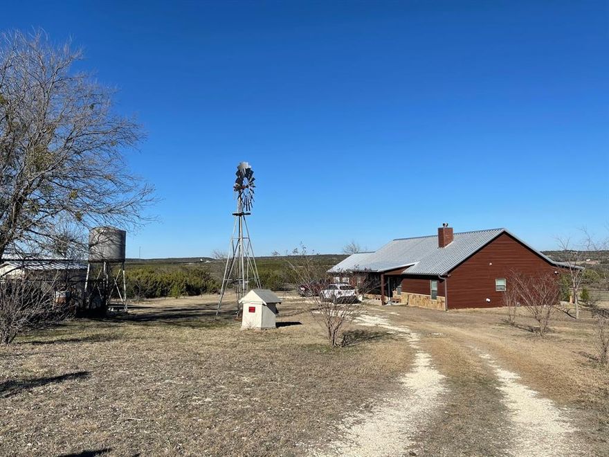 Beautiful Rustic Ranch sitting on approx, 25 acres, covered in gorgeous trees, Nice grass, and great fences. Bring your animals and come enjoy the views, 2 ponds, retro barn, working windmill, on the property and it actually pumps water.  The Original Family Home, 1406sq. ft. was built in the 1940s, and was lived in up to 8 years ago. Just needs a little TLC, Has strong bones and would be a great rental, Newer electric, and some update on plumbing, Air BnB, bunkhouse, she shed, man cave, etc etc. The main house was built in 2018, 1836 sq. ft. open light and bright. Beautiful stone, wood burning Fireplace in the living room, gives that cozy home feel. Split bedrooms, nice size closets, and bathrooms. Sit on the front or back covered porches, watch the deer drink from the ponds, the hummingbirds buzz, the coyote singing, or the beautiful sunsets, as God paints the sky. New floors throughout the house, New roofs on everything on property.  Perfect location backs up to Rough Creek Lodge, close to Hico, Glen Rose, Three-Way and Stephenville. A Perfect spot for the Family, an RV park etc. Motivated Seller, property can be divided, survey is being completed.