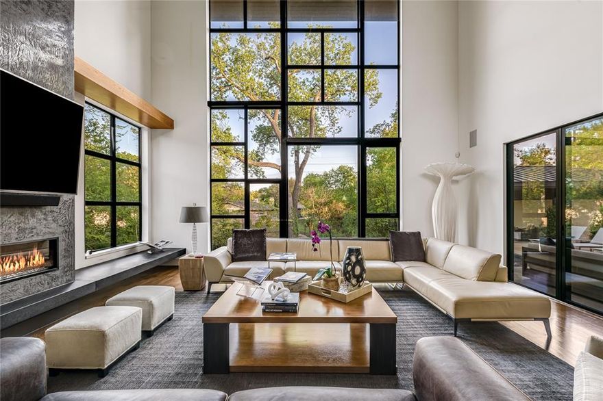 Featured on the AIA Home Tour in 2020, this architect-designed contemporary home combines the finest in design, craftsmanship, and setting. Located in the desirable Hockaday Neighborhood, and designed and built by acclaimed architect Doug Guiling, AIA, and completed in 2018, this architectural masterpiece sits gracefully on a lush creek lot along iconic Strait Lane. This exceptional home was thoughtfully designed to capture the serenity and beauty of its natural surroundings, with expansive walls of glass and custom Mondrian-style windows that flood the interior with light and frame picturesque views of the mature trees, beautifully designed landscaping, and the tranquil creek beyond. A striking oversized entry door opens to reveal a curated art wall and a breathtaking two-story great room. Here, the open-concept living and dining spaces flow into a chef’s kitchen outfitted with premium appliances, custom cabinetry, and easy access to the outdoor living spaces—including a resort-style pool and spa, covered cabana with full bath, firepit, and outdoor kitchen. The main level is anchored by a serene primary suite, which enjoys uninterrupted views of the creek, direct access to the spa and pool and a lower patio with screens and heaters. The primary bath is bathed in natural light and features a soaking tub, oversized walk-in shower, dual vanities & a walk-in closet with extensive cabinetry and secondary laundry hook-ups. A guest suite, office with half bath, a wet bar and chilled wine room, catering kitchen, butler’s pantry, mudroom with dogwash, and access to three garage bays with workshop complete the first floor. Upstairs, three en-suite bedrooms are complemented by a living area that opens to a covered terrace, laundry, and a glass-walled 2nd office overlooking the great room and verdant grounds. Outfitted with Control4 smart home technology for lighting, security & automation, this home blends elegance with modern convenience in a quiet estate location.