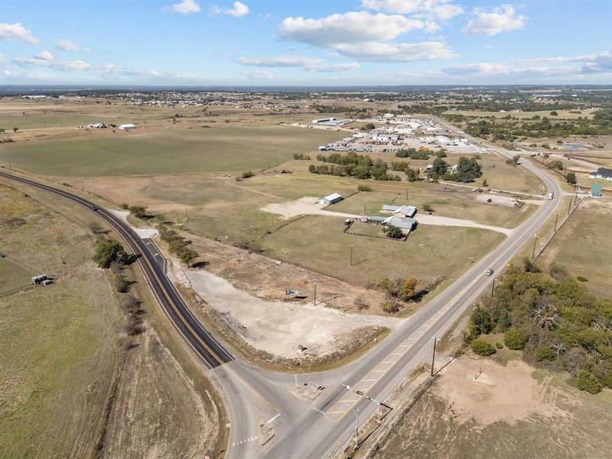 Highly sought-after Peaster ISD location! This 13.7-acre property offers endless commercial development possibilities with frontage and access on state highways FM 920 and FM 1885. No city zoning or restrictions provide ultimate flexibility. Includes two homes and a shop currently rented, generating interim income. Perfect canvas for your next commercial project in a rapidly growing area.