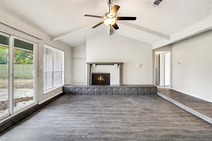 Beautifully updated three bedroom two bathroom home offering a spacious and functional layout with recent interior improvements throughout. The living area features vaulted ceilings with exposed beams, a wood burning fireplace, and large windows that bring in excellent natural light. A sliding door provides easy access to the backyard and patio.

The updated kitchen includes granite countertops, painted cabinetry, stainless steel appliances, and generous counter and storage space. A dining nook sits just off the kitchen with a view of the backyard.

The primary suite includes a large two room layout, an updated vanity with granite counters, a walk in tiled shower, and a private toilet room. Secondary bedrooms offer ceiling fans and low maintenance flooring. Both bathrooms have been refreshed with modern fixtures.

The exterior features a large fenced backyard with mature trees, a concrete patio, and plenty of usable space. An attached two car garage provides secure parking and additional storage. This home is conveniently located near schools, shopping, and major roadways and is ready for immediate occupancy.