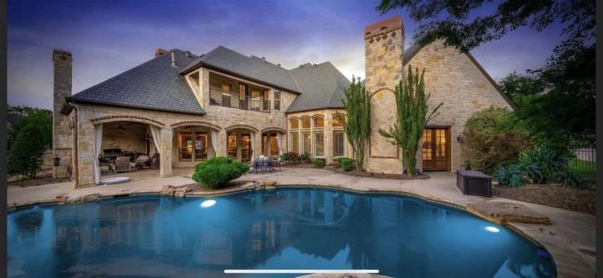 Situated on 1+ acre, this stunning home features 5 ensuite bedrooms, 2 half baths, gameroom, media room, Xtra large wine cellar, 2 offices and two oversized garages. The resort-worthy outdoor oasis has a saltwater pool, hot tub, and a spacious outdoor living area with a fireplace, dining area, and built-in grill. The master retreat offers space to relax & a spa-like bath with dual vanities & 2 walk-in closets. BOTH offices feature built-ins & fireplaces. Gameroom with wet bar and balcony overlooking the park-like backyard. Soaring ceilings, open floor plan, exquisite millwork and custom built-ins throughout. Work from home in 1 of 2 offices. The gourmet kitchen features double ovens, oversized center island, pot filler, veggie sink in island, walk-in pantry, and tons of prep space. This home is the perfect environment for relaxing & entertaining! Owner is a licensed real estate agent.