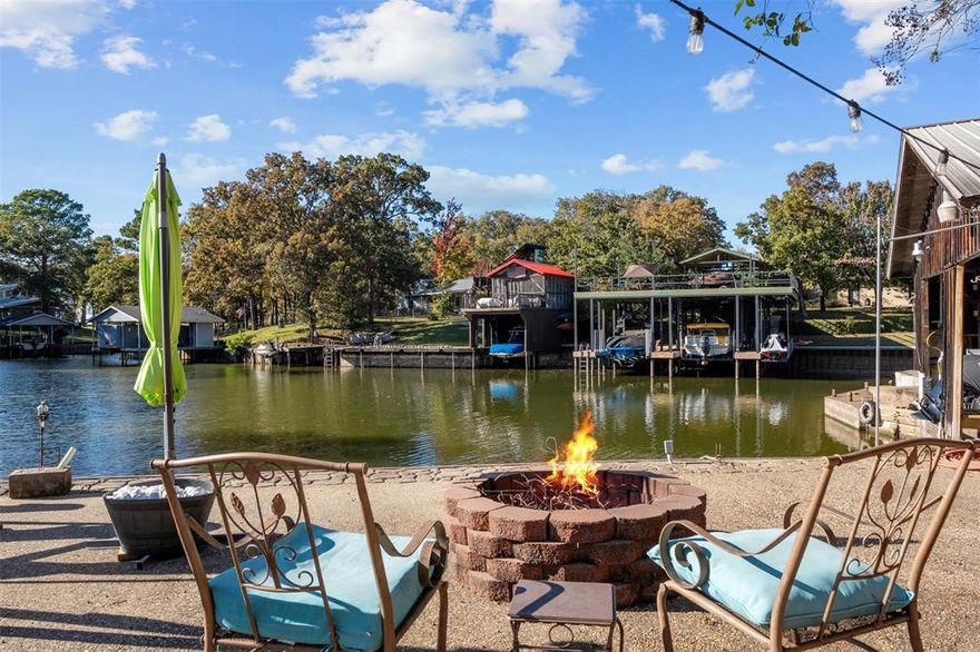 104 Oakcrest Court is a true lakefront escape where relaxed comfort meets the spirit of a classic Texas lake camp. With a protected cove water location in Trinidad, this charming 4-bedroom, 3-bath home offers just over 2,000 square feet of indoor living space designed for effortless lake life. The open-concept layout flows easily from the kitchen and living area to a spacious backyard and waterfront deck built for gathering, grilling, and sunset views. The enclosed boathouse is ideal for storing your boat and water toys, or simply unwinding with a fishing pole in hand. Inside, you’ll find a warm, casual atmosphere that captures the nostalgia of lake weekends, with plenty of room for family and friends to spread out and relax. Whether it’s morning coffee on the deck, afternoons on the water, or evenings under the stars, every detail invites you to slow down and enjoy the view. With its protected shoreline, spacious outdoor living areas, and true lakefront access, 104 Oakcrest Court is the perfect blend of function, fun, and timeless lake house charm.