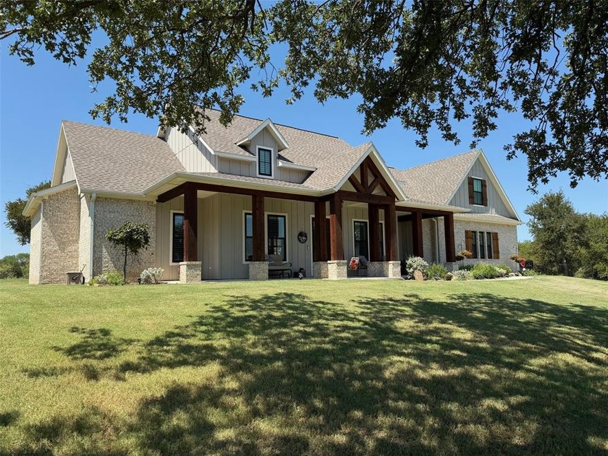 Gated community offers tranquil lake country living with your own hillside retreat in quiet cul-de-sac with envious view of the hills of beautiful Lake Bridgeport. Nicely manicured sloping front lawn and landscaping compliment striking brick and stone architecture with cedar accents surrounding wrap-around covered front porch. Open concept home design is light and bright with abundant windows and 10-feet ceilings. Impressive granite kitchen has stainless appliances including double ovens and five-burner gas cooktop along with 42-inch upper cabinets, island with sit-up bar, and under cabinet lighting. Adjacent to the kitchen is the dining area, impressive wet bar complete with granite counters and icemaker, walk-in pantry, built-in planning center, half-bath, and laundry room with granite counters, sink, and generous storage. Kitchen is also nicely open to the family room that has a wall of built-ins surrounding brick fireplace with gas logs and cedar mantle, vaulted ceilings up to a 17-foot peak with a cedar beam, and two walls of windows supplying plenty of natural light. Two secondary bedrooms have ceiling fans and walk-in closets and share a Jack & Jill bathroom with separate vanities with ample storage, and spacious shower. Private master suite is on the opposite side of the home that has vaulted ceilings and elegant ensuite bathroom featuring large granite vanity area with dual sinks, soaking tub, separate shower, water closet, and enormous walk-in closet. Covered rear patio is an exceptional retreat complete with outdoor kitchen including built-in grill and refrigerator area with granite countertops, flat screen TV, and lush lawn surrounded by wrought-iron fence, and nice trees with hillside views in the background. Home also has Plantation Shutters throughout, sprinkler and security systems. HOA includes basketball and pickleball courts, community pool, and boat ramp and dock providing access to the lake.