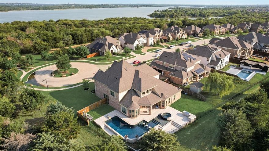 DECOR ALLOWANCE AVALABLE FOR AN ACCEPTABLE OFFER: Experience the pinnacle of sophistication at 2704 Neblina Court, a true architectural masterpiece in the coveted Las Brisas Estates of Mira Lagos. Set on a sprawling cul-de-sac lot within a private gated enclave, this estate blends cinematic grandeur with modern luxury. Six bedrooms and five baths offer refined comfort, complemented by a stately office, game room, home theatre, and versatile bonus space for seamless multi-generational living. Interiors inspired by Caesars Palace grandeur flow effortlessly from a gourmet kitchen with premium finishes to expansive living areas designed for entertaining or quiet indulgence. A breathtaking custom ceiling mural reminiscent of Caesar’s Palace sets the tone for elevated living, while a whole-house power inverter, premium surveillance system, and water softener ensure comfort, security, and uninterrupted luxury. The primary suite is a serene sanctuary with a freestanding soaking tub, walk-in shower, and a closet ready to embrace a bespoke organizational vision. Outside, a resort-style 15-ft pool gracefully wraps around the home, with cascading waterfalls and fire bowls creating a dramatic ambiance for twilight soirées. Framed by serene vistas near Joe Pool Lake, this estate is the embodiment of Texas luxury, lifestyle, and timeless sophistication.