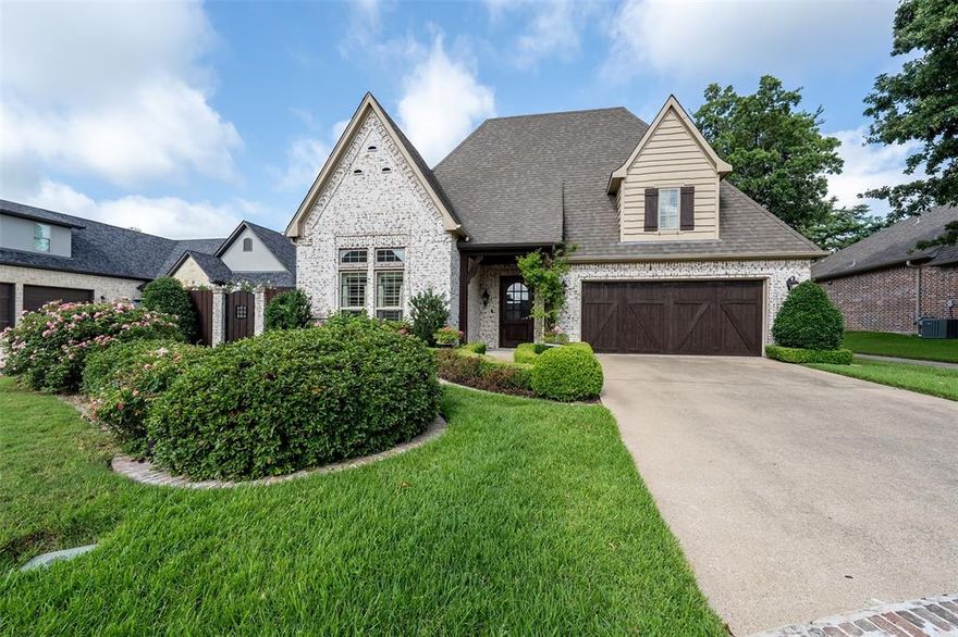 Welcome to this beautifully appointed 3 bedroom, 2 bathroom home with flexible 4th bedroom that can serve as a game room, home office or guest space.  Enjoy multiple living areas, including a cozy living room with a gorgeous fireplace and a sunroom with a wall of windows to bring the outdoors in.  The kitchen is a chef's dream featuring a 4 burner gas range, large center island, built in microwave, ice maker, farmhouse sink and spacious dining area.  All enhanced by a tankless water heater for efficient comfort.  Three smart thermostats keep the home climate just right!  Retreat to the primary suite with vaulted ceilings, backyard access, and a warm gas fireplace.  The luxurious primary bathroom offers a separate garden tub, oversized shower, double vanity and a large walk in closet.  Outside, enjoy lush landscaping, whether in the front or back of the fenced in yard, which backs up to a walking trail, and has a built in gas line for your preferred grilling device.  A generator provides peace of mind year round, and the attached 2 car garage completes this versatile move in ready home.