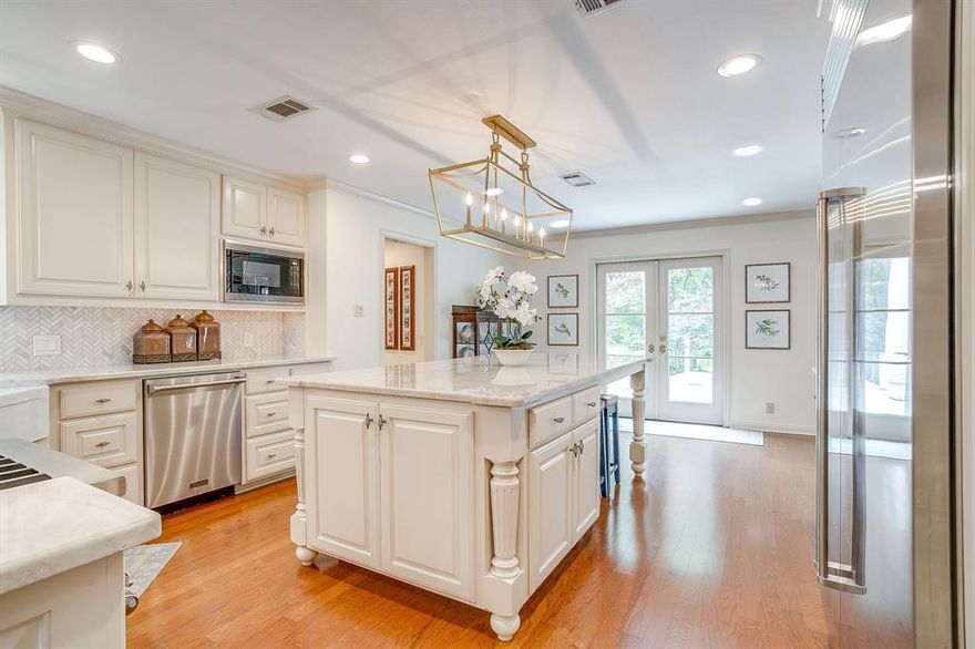 Nestled in the heart of prestigious Westover Hills, 1905 Indian Creek Drive offers more than just luxury and living- this is a sanctuary designed for those who value peace, privacy and security. Situated on over a half acre of lush, mature landscaping, the home is set back from the street to ensure serene seclusion. As you approach the circular drive, you enter the home with a grand entrance, complete with tall ceilings and floor to ceiling windows that all face the backyard and pool. This home is the ultimate entertainer's paradise, equipped with state of the art appliances in the kitchen and open spaces for dining and entertaining. A formal dining room that has a wet bar and fireplace, is the perfect setting for family dinners or holidays. There are two additional spaces for gathering, one is the main living room that opens up to the backyard. The other is a more formal living space that could also be used as an excellent first level home office. The primary suite is conveniently located on the first level as well, while the additional three oversized rooms are upstairs, along with a flex space or playroom. A perfect spot for children or teenagers to gather! The house has a wonderful family feel that allows for everyday comforts, but has all of the modern amenities. The renovation spans the home throughout and the tiered backyard, new decking, bridge, putting green, fire pit and tree house really attract the most attention. There is even a ladder down to Indian Creek, which runs right into the backyard. Whether you prefer to grill and serve in the outdoor kitchen, practice your short game on the putting green or just relax with a glass of wine by the fire pit- this home has it all. There is abundant storage, including parking for a golf cart, which is ideal for golfers with Shady Oaks golf course just a short golf cart ride down the street. The updates are even prettier in person and the views of the lush backyard and pool are spectacular!