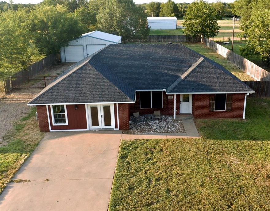 Discover comfort and flexibility in this 3-bed, 2-bath brick home on a half-acre lot just minutes from Lake Bonham. The roof was replaced in 2018, and fiber optic internet service is available for fast, reliable connectivity. The converted garage offers versatile space that can serve as a large office, second living area, or even a fourth bedroom. A spacious 30x30 workshop features two roll-up doors in the front and one in the back, perfect for projects, storage, or hobbies. Water is available for RV use, and buyers may add RV electric hookups if desired. The fenced backyard provides plenty of room to relax and play. Located outside the city limits with no HOA, this property combines freedom, functionality, and convenience—all less than 10 minutes from the lake.