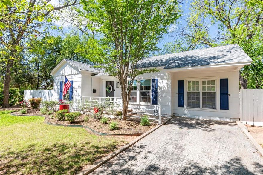 Your reimagined storybook cottage, nestled amongst the soaring trees of the highly desired Elmwood neighborhood, is ready for its next chapter. Meticulous landscaping and bright shutters accent this Craftsman style home, where a welcoming porch invites you to slow down and stay awhile. Inside, preserved charm blends seamlessly with modern amenities to create a true oasis, as original hardwoods pair beautifully with a clean, crisp color palette and playful accent walls. An open concept layout effortlessly combines two living spaces with a central dining area, making it ideal for gathering and hosting loved ones, while updated, efficient windows bathe the home in natural light. A cozy gas fireplace anchors the second living area, adding warmth and ambiance, while the thoughtfully designed new kitchen offers ample quartz prep space, an island with bar seating, a sleek cooktop and wall oven, and a striking dimensional subway tile backsplash, all overlooking pristine, cottage style gardens. A spacious walk in pantry, rare for a home of this age, adds both charm and function. The primary bedroom serves as a peaceful retreat with direct access to a beautifully styled screened in side porch that also connects to an additional secondary room, while the well equipped bathroom features a showstopping walk in shower with glass door. A third bedroom enjoys convenient access to a second full bath, and a unique basement provides treasured extra storage. Outdoors, your story continues in the redesigned backyard, perfect for cookouts and quiet evenings alike, with bright privacy fencing, a gorgeous paver patio, a gas fireplace hookup, and the shade of mature trees creating a serene setting. Here, an idyllic and charming lifestyle is not just imagined, it is waiting to be lived.