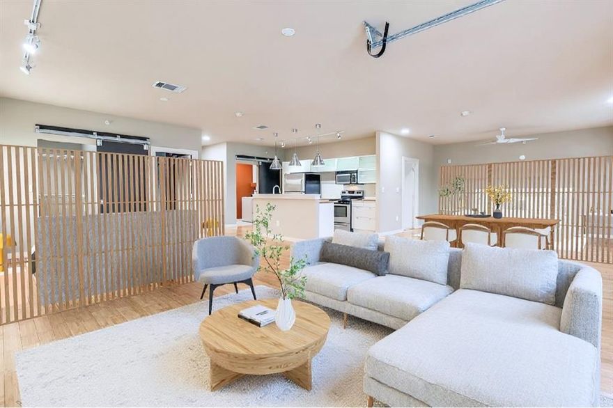 Discover a rare opportunity to own a corner loft condo offering a 2 bedroom, 2 full bathroom open configuration, 1152 sqft of modern urban living, 2 assigned parking spaces (tandem) - complete with INCREDIBLE downtown Dallas views. Located in a gated community in The Cedars, this home places you at the center of a vibrant district known for its energetic nightlife, eclectic art galleries, and immediate proximity to Downtown Dallas. Designed with an urban open-loft aesthetic, this home features modern finishes, high ceilings, and a flexible open layout that adapts easily to your ideal living arrangement. A striking roll-up garage-style door extends the living space onto the wrap-around corner balcony, where views of Akard Street and the Downtown skyline provide the perfect setting for entertaining or relaxing. Bamboo hardwood flooring is located throughout to create a seamless transition for the open floorplan.  The sleek island kitchen is at the center of this space and offers frameless modern white cabinetry, deep storage drawers, butcher block countertops, stainless steel appliances, and a dual-basin stainless sink with high-arc pull-down faucet. The spacious primary bedroom area features an open wood-and-metal dual-sink vanity with a wood countertop, a tub-shower combo with glass sliding doors, white ceramic tile finishes, and a large walk-in closet. The guest bedroom area offers its own walk-in closet with a modern barn-door entry, along with a white vanity, oversized porcelain sink, and white ceramic tile finishes. Additional highlights include an oversized utility room with full-size side-by-side connections that is closed off by a modern sliding barn door. This Buzz Lofts offers an urban lifestyle with an elevator, rainwater harvesting system, secure bike and storage area, and unmatched walkability to restaurants, shops, major highways, the DART Line, and all the culture of the Cedars District - just moments from Downtown Dallas.