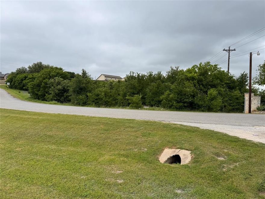Great development property surrounded by 3 neighborhoods.  Close to Hwy 377, Kroger, and HEB.  City utilities available, road frontage on 2 sides.