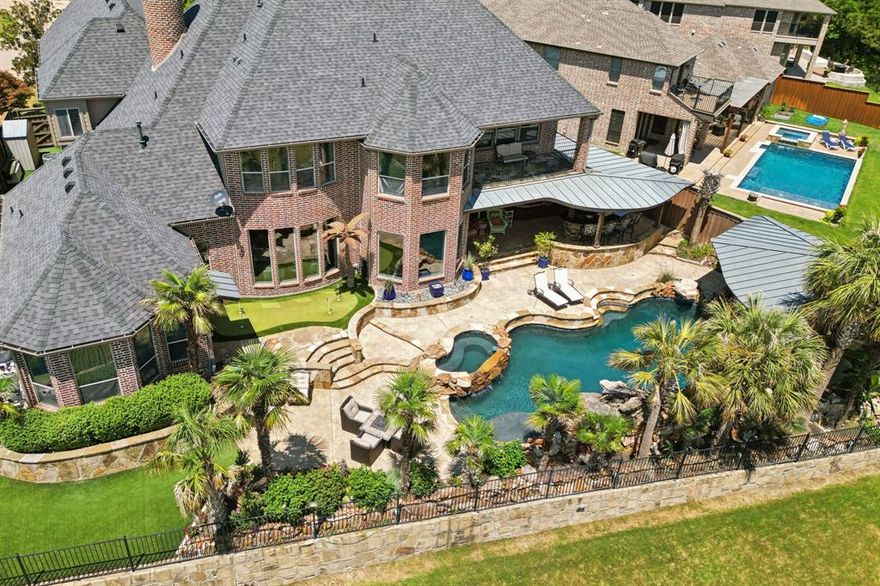 IMAGINE YOURSELF LIVING A LAVISH VACATION LIFESTYLE EVERY DAY! 20 miles from Dallas, in Rockwall County, TX's best kept secret..its smallest yet wealthiest county! WATERFRONT RESORT-STYLE LUXURY OASIS on the shores of Lake Ray Hubbard! Nestled in the RGAC community of The Shores with Golf, Tennis, Pickle Ball, Work-out Facilities, Restaurants & more!* And just minutes to marinas, shopping, more restaurants, entertainment. Resort-level entertaining backyard with views & sunsets that won’t quit! Commercial grade outdoor kitchen & bar, expansive metal & cedar ceiling patio w-built in infrared-heaters, diving pool & spa, cabana with FP, putting green, dog run, turf, half bath w-back patio access for convenience & so much more! STUNNING architecture & millwork throughout, including extensive REAL MAHOGANY! Nearly every window in this 6100+sqft, 5bed-5.1 bath home has VIEWS OF THE LAKE! Remodeled CHEFS KITCHEN has large island, Wolf appliances *gas stovetop & double ovens*, ice maker & Sub Zero Fridge. Hand-scraped wood floors! HUGE, GORGEOUS, Soundproof Home Theatre with 120inch screen, stadium seating for 10+ & extra entertaining room! Multiple Coffered Ceilings including in the downstairs EXECUTIVE OFFICE! Master down…wake up in awe of your RESORT LIVING & LAKE VIEWS! 1 other bed & bath down. Upstairs:3 large bedrooms with en-suite baths & walk-ins—any could be an ideal in-law suite! Expansive upstairs space for all your needs! CRESTRON SMART HOME & SECURITY SYSTEM TECHNOLOGY, storm-safe room, WiFi commercial grade repeater, indoor-outdoor speaker system, XL 3 car garage with built-ins & workbench. Built with 70+ piers under slab, bug mister system, home fire sprinklers! Somethings are just too extraordinary for words alone and therefore MUST be seen and experienced…THIS is one of those things!! Gets GREAT feedback, just looking for someone who doesn't need an *at home* boat dock! Is that YOU?! Book your Showing & find out! *RGAC Membership available, but not included.