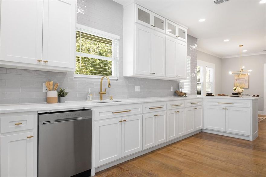 Just a short stroll from the energy of Bishop Arts, this Craftsman home feels like the perfect blend of vintage soul and modern comfort. The oversized front porch sets the tone—morning coffee, evening wine, and friendly neighborhood hellos all happen right here. Inside, sunlight pours across rich hardwood floors, giving the home a warm, collected feel. The living area is anchored by a sleek modern fireplace, creating a cozy spot for movie nights or quiet weekends at home. The kitchen delivers cool, contemporary style with fresh cabinetry, crisp counters, and stainless appliances—all opening to a relaxed dining and lounge space that feels effortlessly social. Three well-sized bedrooms offer flexibility for guests, a home office, or creative space. The updated bathrooms feature clean lines, frameless showers, and thoughtful finishes, with the primary suite enjoying a spa like bath with a rainfall shower and two sinks. Out back, the huge fenced yard feels like your own private park—lush, quiet, and ready for pets, projects, or future entertaining. Major system upgrades have already been handled, so you can simply move in and enjoy the lifestyle. And when you want to explore, Lake Cliff Park is just blocks away with its pond, walking paths, and shady lawns—not to mention an endless lineup of local restaurants, cafés, and shops nearby. If you love the character of an older home but want modern comfort and a cool neighborhood vibe, this one checks every box.