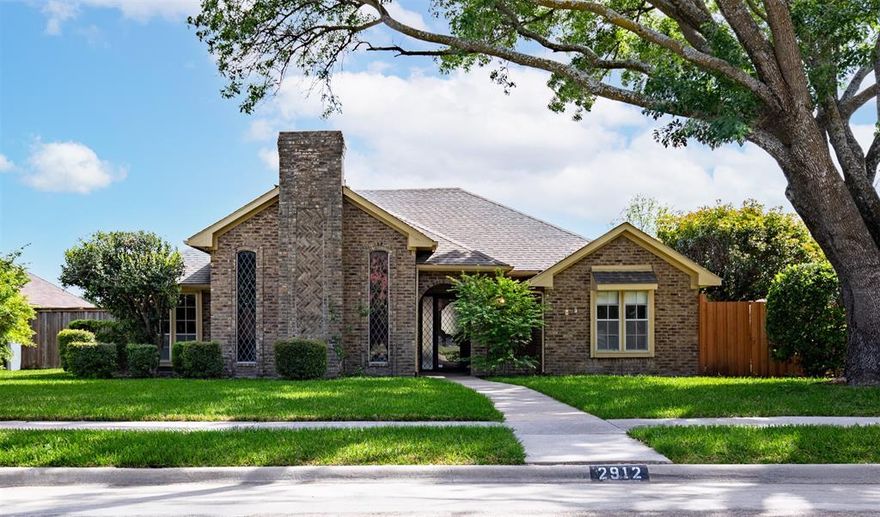 Beautifully updated single-story home nestled on a spacious cul-de-sac corner lot in Parker Road Estates. This 3-bedroom, 2-bath residence offers approximately 2,010 square feet of thoughtfully designed living space with multiple living and dining areas. Step inside to find fresh interior updates, including engineered hardwoods throughout the home, modern decorative lighting, and a bright, neutral color palette. The expansive living room showcases vaulted ceilings with exposed beams, beautiful oak paneling, and a striking floor-to-ceiling brick fireplace, creating a warm and inviting focal point. A secondary family room and enclosed sunroom provide flexible spaces for relaxing, working, or hosting guests. The kitchen features ample cabinetry, updated countertops, stainless steel appliances, and a cozy breakfast nook. The private primary suite offers generous space, a remodeled ensuite bath with dual sinks, separate shower, and walk-in closet. Two additional bedrooms are well-sized and share a beautifully updated full bath. Enjoy outdoor living in the fenced backyard with mature trees, open patio space, and room to garden or play. Rear-entry garage with alley access enhances curb appeal and functionality. Located within Plano ISD and just minutes from the best shopping, dining, and parks, this home combines classic charm with modern updates in an unbeatable location in central Plano. Close proximity to PGBT for easy commute to both I-75 and DNT.