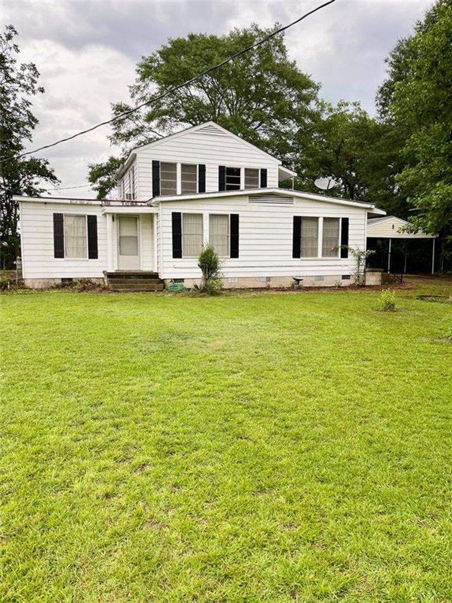 This mult-family home features 3 bedrooms and 2 bathrooms on the first level, accompanied by a kitchen and living room. The second-level apartment boasts 1 bedroom and 1 bathroom, complete with a stacked washer and dryer in the bathroom, living room, and kitchen. The property also includes a basement with dual entryways. Notable exterior features comprise a pool house, two sheds, and a greenhouse. Additionally, the property offers three extra parking spaces in front of the home and a 2-car carport. The apartment is needing a little TLC. AS IS Sale. Schedule an appointment today with a realtor today!