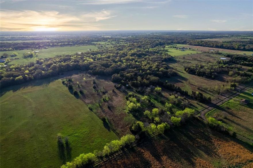 This Hopkins County property near Sulphur Springs, Texas offers a mix of open pasture, hardwood timber, and surface water, providing potential for recreational use, agricultural activities, or a homesite, subject to buyer verification of intended uses and local requirements. The land includes a balance of pasture and hardwoods, with open areas that may support grazing or hay production and wooded areas that provide shade, wildlife habitat, and natural diversity. A pond is located on the property and may serve as a water source for livestock as well as offer recreational fishing opportunities while attracting wildlife. Access is provided by a county-maintained road with approximately 485 feet of road frontage, allowing for convenient entry and potential for multiple access points. The property includes a gated entrance and partial fencing; buyers should evaluate condition and suitability for their intended use. Electricity and water are reported to be available along the road; buyers should independently verify availability, capacity, and connection requirements with utility providers. The property is located approximately 15 minutes from Sulphur Springs, offering access to retail, dining, and services, and is also within approximately 15 minutes of Cooper Lake State Park and Jim Chapman Lake, which provide opportunities for fishing, boating, and outdoor recreation in accordance with applicable regulations. The location offers access to TX 24 and Interstate 30, supporting travel to surrounding areas. This tract may be suitable for hunting, wildlife observation, agricultural use, or a future homesite, subject to buyer verification of zoning, permitting, utilities, and restrictions. All information is deemed reliable but not guaranteed; buyer and buyer’s agent to verify all information.