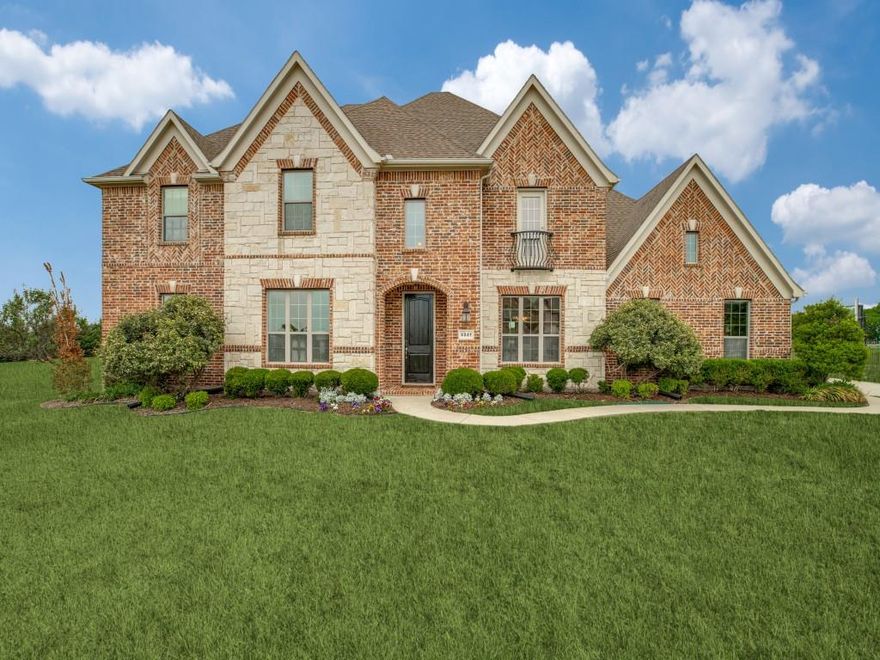Set behind the gates of the coveted Waterstone Estates, this extraordinary one-acre estate delivers a seamless blend of timeless elegance & elevated modern living.   Only 15 minutes from historic Downtown McKinney, get the wide open spaces you've been dreaming of with a short drive to anything you need!

From the moment you arrive, the striking brick and stone façade makes a lasting impression. Step inside to a grand, light-filled interior where every space has been intentionally curated. A private executive study offers both style and security, featuring custom built-ins, a sliding barn door & direct access to an above-ground tornado shelter & secure family safe room. At the heart of the home, a breathtaking 2 story living room showcases soaring ceilings, rich hardwood floors + a dramatic brick fireplace, all wrapped in natural light. The open-concept layout flows effortlessly into a chef-inspired kitchen designed to impress, complete with an expansive granite island, gas cooktop, double ovens, SS appliances, and eye-catching triple pendant lighting. Just beyond, the spacious breakfast nook overlooks the peaceful backyard, creating a serene setting for everyday moments. The primary suite is a true sanctuary, highlighted by tray ceilings, custom wainscoting + oversized windows that invite in soft natural light. The spa-like ensuite bath elevates daily living w-dual vanities, a soaking garden tub, separate shower and a thoughtfully designed custom closet. Upstairs, you’ll find a versatile game room, loft-style workspace & 3 generously sized guest bedrooms. Additional highlights include a rare 4 car garage (WITH ELECTRIC CHARGER) & a beautifully designed utility room with shiplap accents and ample folding space. Living in Waterstone Estates means enjoying exclusive access to scenic amenities, including a private lake, park, playground, and gathering pavilion, perfectly complementing the peaceful, upscale lifestyle this remarkable property provides.