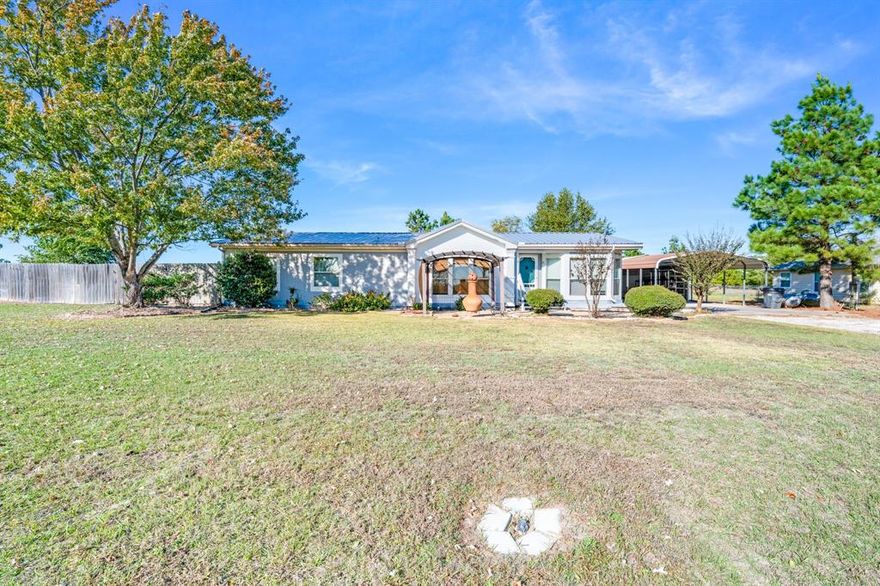 Country Charm Meets Modern Comfort!
Welcome to 140 County Road 2302 in Sulphur Springs, TX — a beautiful 1998 Valley Classic modular home with 1,860 sq. ft. of living space on over half an acre!

This inviting 3-bedroom, 2-bath home includes a formal dining room, home office or library, and tons of upgrades — from the brand-new metal roof (April 2025) to new flooring, water heater, dishwasher, and disposal.

Enjoy outdoor living under the front pergola, relax on the 12x20 back patio, or make use of the 20x20 shop, RV hookup, and covered carport. The fenced backyard and 50x20 gravel driveway complete this move-in-ready gem!