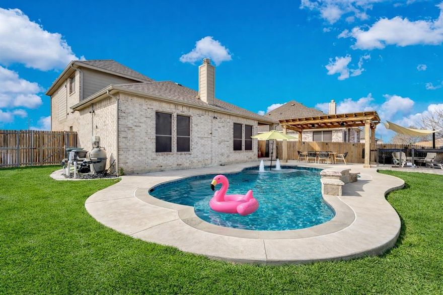Welcome to this beautifully maintained 5 bedroom home with a sparkling backyard pool in sought after Midlothian ISD. Offering 3 full bathrooms and a flexible floor plan, this home is designed for both everyday comfort and effortless entertaining. The spacious layout features two living areas, providing room to spread out for movie nights, a game room, or a dedicated home office. The primary suite is conveniently located downstairs along with a secondary bedroom and full bath, making it ideal for guests or multigenerational living. Upstairs you will find additional generously sized bedrooms and another full bath, offering privacy and space for everyone. The open concept kitchen overlooks the main living area and dining space, creating the perfect flow for gatherings. Enjoy granite countertops, stainless steel appliances, ample cabinetry, and a large island with seating. Natural light fills the home and highlights the neutral color palette that complements any style. Step outside to your private backyard retreat featuring a custom in ground pool with water features, an extended concrete patio, and a covered pergola with outdoor dining space. The lush green lawn and added landscaping create a welcoming outdoor environment perfect for summer entertaining or relaxing evenings at home. Additional features include a storage shed, wood privacy fence, and a spacious driveway. Located in a desirable neighborhood within Midlothian ISD and close to shopping, dining, and major highways, this home offers the perfect combination of space, location, and lifestyle. If you are searching for a 5 bedroom home with a pool in Midlothian ISD, this one checks all the boxes. Schedule your private showing today.