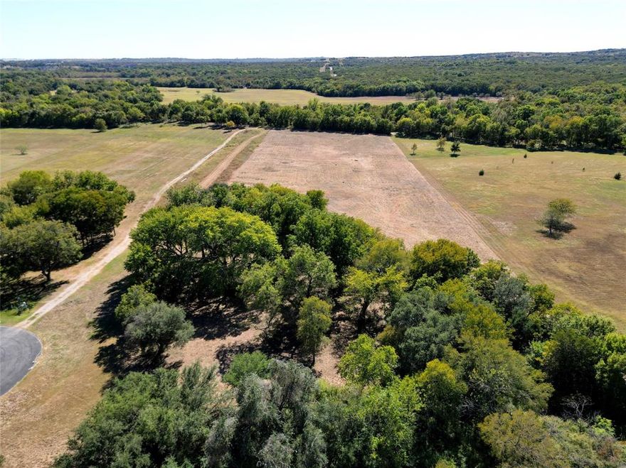 WOW!! Looking for the perfect spot to build your dream home? This 8.81 acre lot is it! Located in an exclusive gated community just 30 minutes to downtown Fort Worth. The property is situated on a lovely treed cul-de-sac next to the equestrian trails in the subdivision. The land is flat and ready to build on, plus it has a nice pasture area in the back, perfect for horses or coastal hay. A wonderful setting for your custom home!