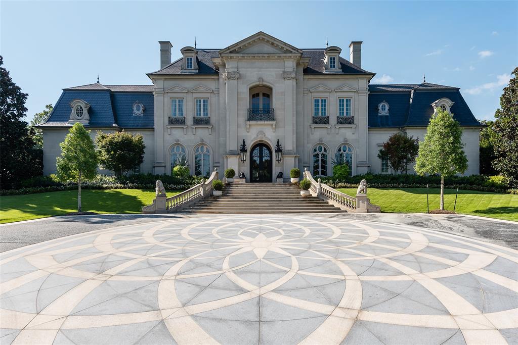 Tucked behind iron gates, this remarkable estate sits on over 2 acres in the heart of Old Preston Hollow. The custom 6-bedroom, 7.3-bath residence, completed in 2014, blends luxurious materials, textiles, and finishes. Spanning nearly 20,000 square feet, the French Renaissance-inspired home offers complete privacy and tranquility. A two-story domed entry features a stunning floating staircase, with marble floors in the Grand Foyer and rich mahogany moldings in the Library, Formal Study, and Media Room creating a dramatic atmosphere. The Grand Dining Room, adorned with de Gournay silk and embroidered wallpaper, offers unparalleled elegance. The gourmet kitchen includes an 8-burner Wolf range, 4 Wolf ovens, induction stovetop, and a center island, complemented by custom cabinetry. An open layout leads to a keeping room, junior dining room, and family room, which opens to a covered outdoor terrace. At the heart of the home, the Grand Hall boasts ornate plaster ceilings, two black marble fireplaces, and stunning marble medallions. The Media Room is a sports enthusiast’s dream, with 5 televisions, a 120” drop-down screen, and a full wet bar. The main level Master Suite includes a private sitting room and opens to a terrace with a fireplace, pool, waterfall, and cabana. His-and-hers master baths feature marble floors, separate dressing areas, including a second story additional master showroom couture closet, and a large double shower. Upstairs, 5 additional bedrooms with luxurious baths include suites with private balconies overlooking the pool and gardens. Other highlights include a Billiards Room, Game Room, Physiotherapy Room with Steam Room, and Home Gym, all accessible by elevator. For car enthusiasts, the estate offers 3 garages with 4 car lifts, providing space for 10 luxury vehicles. The grounds feature a saltwater pool, cabana, walking paths and gardens, creating a serene resort-like atmosphere.