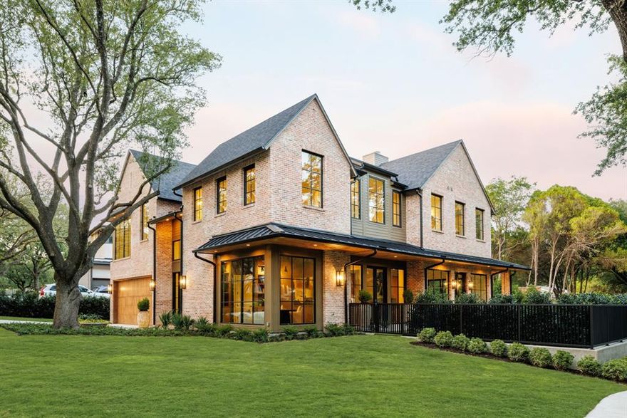 Located on a tranquil,tree-lined street in one of Lakewood’s most coveted neighborhoods,this stunning custom home by Fairmont Homes exemplifies refined transitional design.Positioned on a rare .30-acre private corner lot,the residence highlights exceptional craftsmanship,thoughtfully curated finishes,& premier amenities—delivering an elevated lifestyle just steps from the shores of White Rock Lake.Majestic,towering live oaks surround the home,while the rich patina of natural brick & lush landscaping evoke a timeless,established presence.Inside, soaring 11-foot ceilings & dramatic floor-to-ceiling windows create a light-filled,open atmosphere. Warm,inviting tones carry throughout,complemented by white oak hardwood floors,beautiful millwork,& smooth-finished walls with subtle plaster detailing.The kitchen is a true showstopper,featuring top-of-the-line Thermador appliances,a pantry that exceeds expectations,& a phenomenal banquette breakfast nook designed for everyday elegance.From the kitchen, white oak portals lead into the inviting family room,anchored by a striking fluted concrete fireplace.The space flows effortlessly into the dining room, complete with a sleek wet bar & integrated wine storage.With an effortless indoor-outdoor flow, both the kitchen and family room open via sliding doors to the expansive rear loggia overlooking the pool.Complete with an outdoor kitchen,phantom screens,& in-ceiling heaters,the space is perfectly designed for comfortable entertaining in every season.The sleek modern pool is paired with a huge turf yard,creating a resort-like retreat visible & accessible from the living & dining areas.The study captures sweeping views + private spacious guest retreat.Upstairs you will find the incredible primary suite with spa inspired bath + three spacious secondary bedrooms—each with its own en-suite bath & walk-in closet—alongside an impressive game room & a versatile flex space, ideal for a home gym or second office.Oversized 3 Car Garage