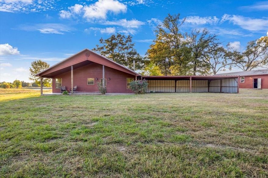 Charming East Texas ranchette on 28 acres, just minutes from town! This 2-bedroom, 2-bath home features solid wood interior walls, vaulted ceilings, and stained concrete floors throughout. The kitchen offers granite countertops and a gas cooktop, and the cozy wood-burning stove adds rustic warmth. Enjoy large, covered porches front and back, both with gas hookups for outdoor cooking. The property includes two ponds one with solar aeration, a floating pier, and stocked with black crappie, copper nose bluegill, and red-eared sun perch. Additional features include a 24x52 shop with electric door, 24x32 horse barn, chicken coop, RV hookup and solar-powered entry gate. Ag exemption in place. Quiet, peaceful East Texas living at its best come see to appreciate!